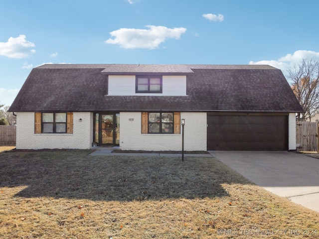 view of front of home with a garage and a front yard