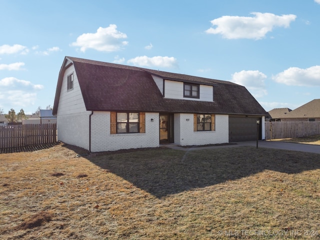 view of front of house featuring a garage and a front lawn