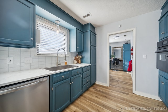 kitchen with dishwasher, sink, backsplash, blue cabinetry, and oven