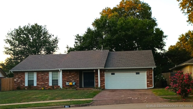 ranch-style home featuring a front yard and a garage