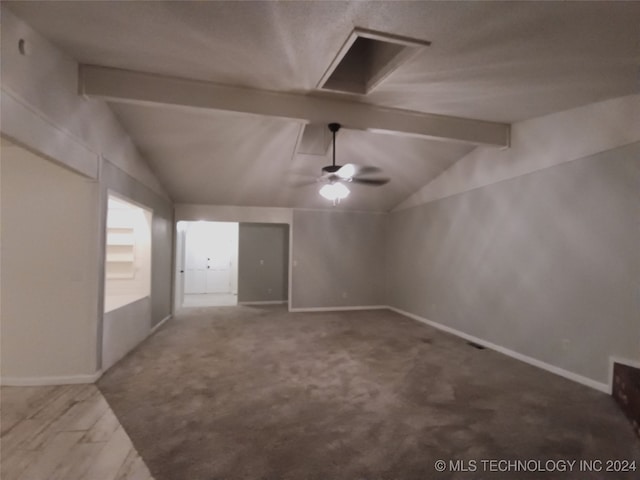 spare room with carpet flooring, ceiling fan, and lofted ceiling with beams