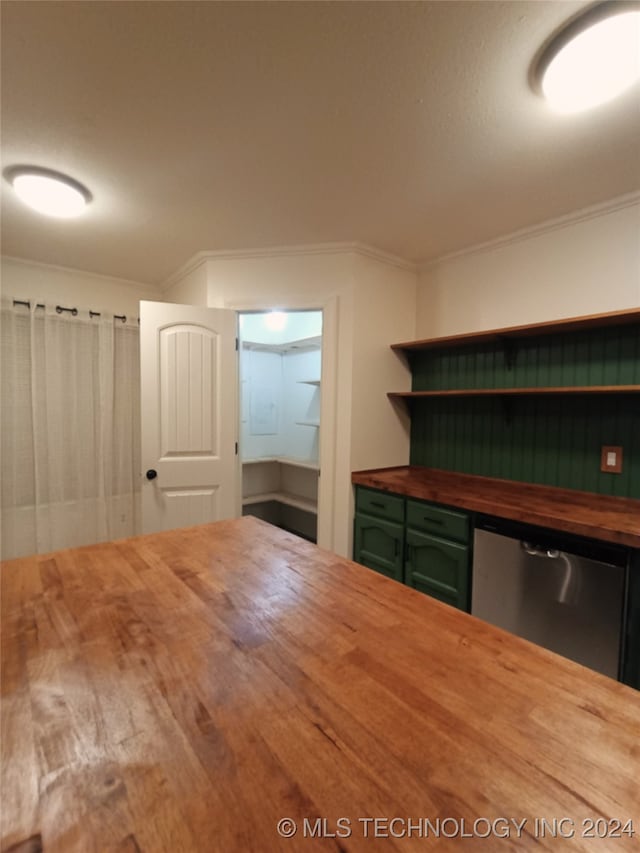 kitchen with hardwood / wood-style flooring, ornamental molding, stainless steel dishwasher, and wood counters