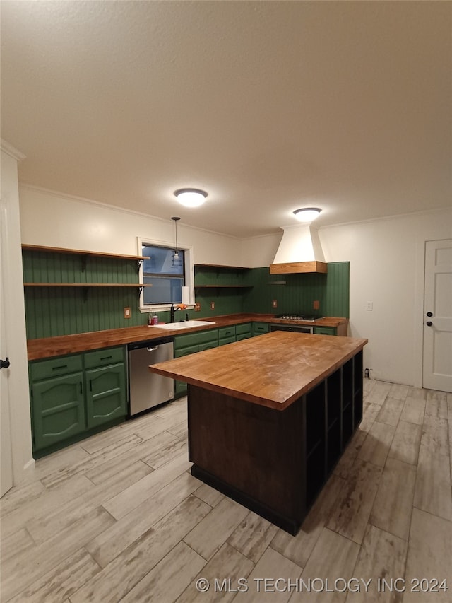 kitchen with stainless steel appliances, sink, green cabinetry, light hardwood / wood-style floors, and butcher block counters