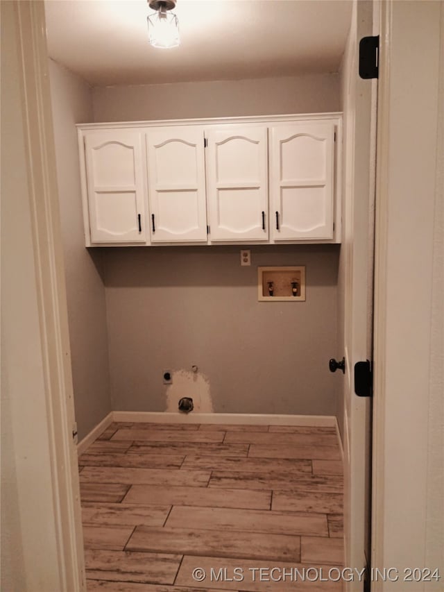 laundry room with cabinets, hookup for a washing machine, light wood-type flooring, and hookup for a gas dryer