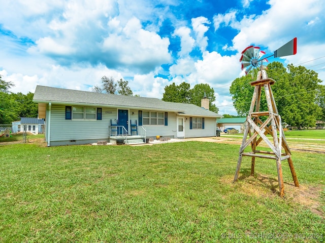 rear view of property featuring a yard