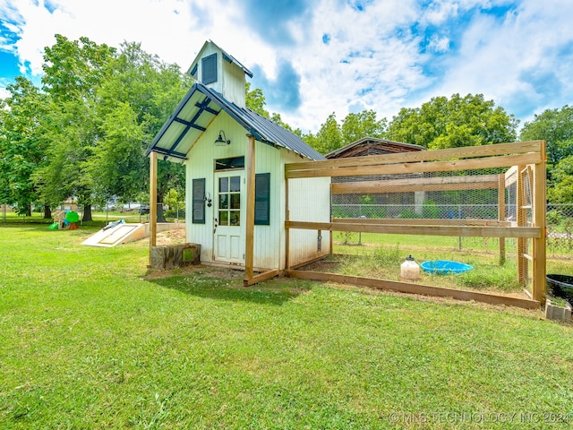 view of outbuilding featuring a lawn