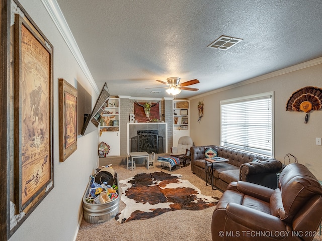 carpeted living room with ceiling fan, a fireplace, ornamental molding, and a textured ceiling