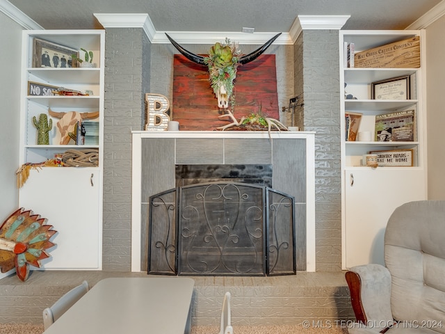 details with a textured ceiling, a brick fireplace, and ornamental molding