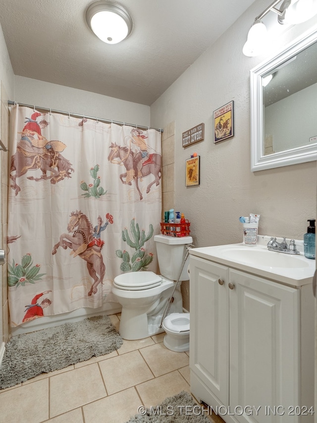 full bathroom with tile patterned floors, vanity, a textured ceiling, shower / bath combo with shower curtain, and toilet