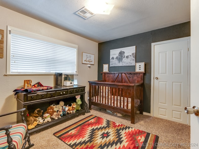 carpeted bedroom featuring a textured ceiling