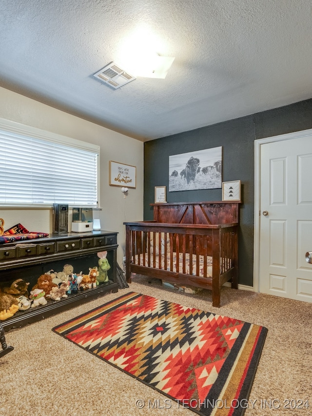 bedroom featuring carpet and a textured ceiling