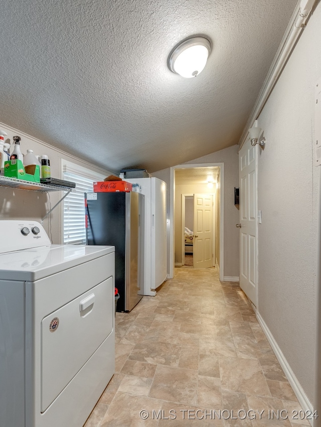 clothes washing area featuring washer / dryer and a textured ceiling