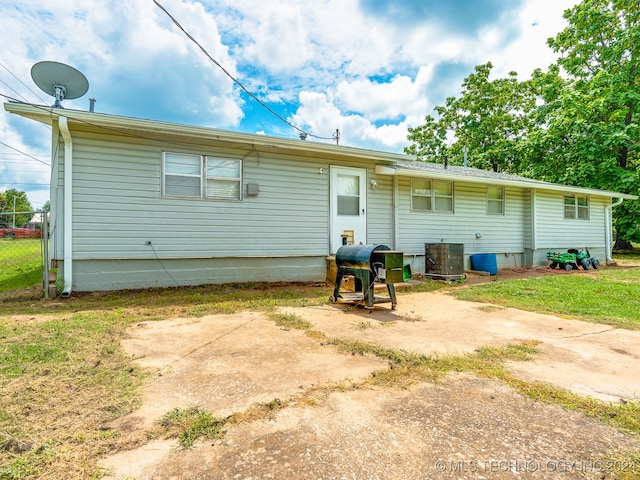 rear view of property with central AC unit