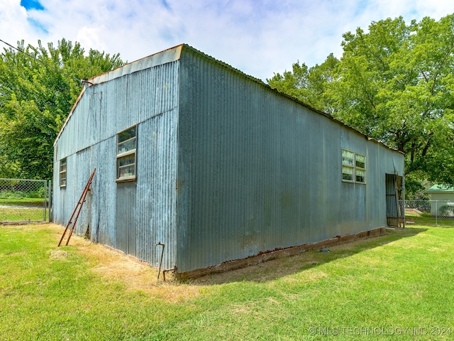 view of outbuilding featuring a lawn