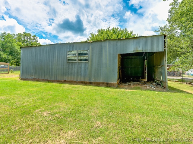 view of outdoor structure featuring a lawn