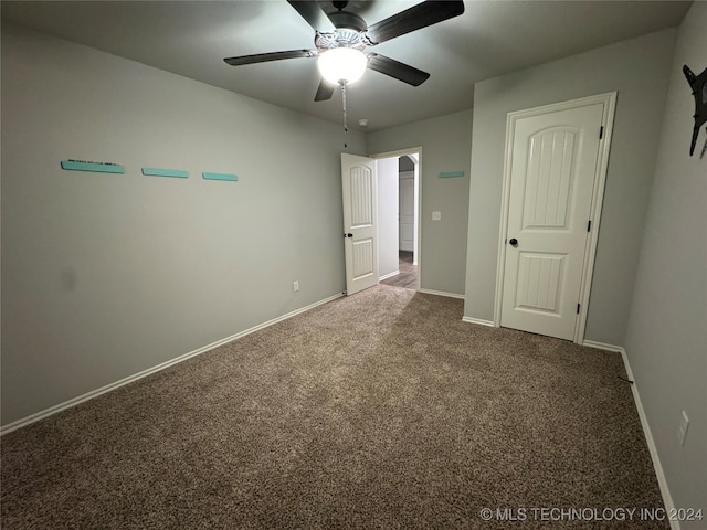 unfurnished bedroom featuring ceiling fan and carpet floors