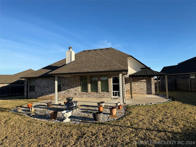 back of house with a gazebo, a yard, and a patio