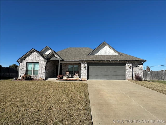 view of front of home with a garage and a front yard