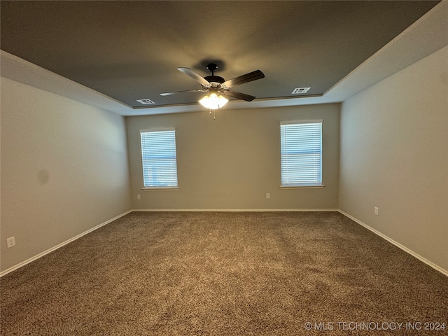 carpeted empty room featuring ceiling fan and a healthy amount of sunlight