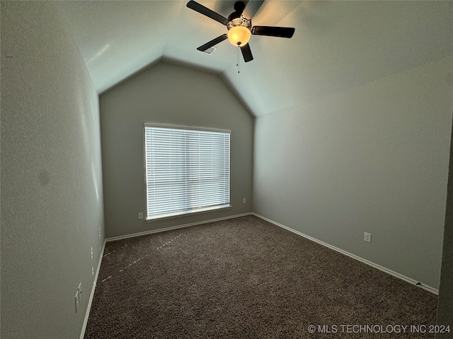 additional living space featuring ceiling fan, lofted ceiling, and dark colored carpet