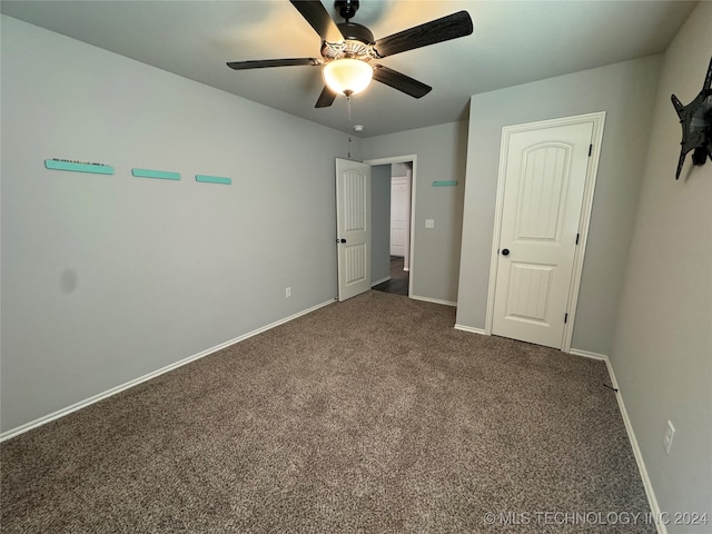 unfurnished bedroom featuring carpet floors and ceiling fan