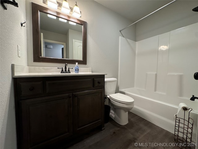 full bathroom with toilet, vanity, hardwood / wood-style flooring, and bathing tub / shower combination