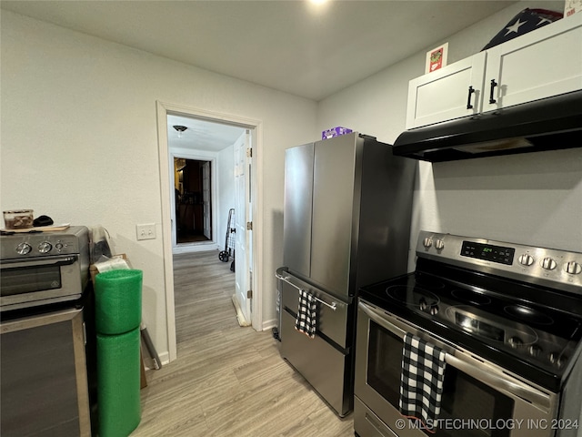 kitchen featuring white cabinets, stainless steel appliances, and light hardwood / wood-style flooring