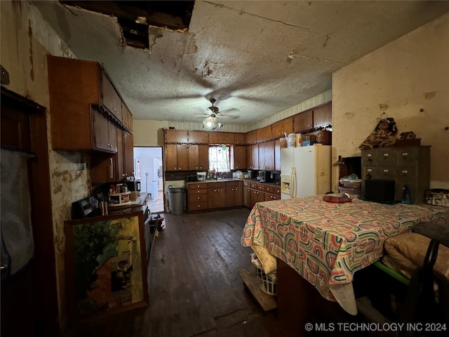 kitchen with ceiling fan, sink, dark hardwood / wood-style floors, white refrigerator with ice dispenser, and a textured ceiling