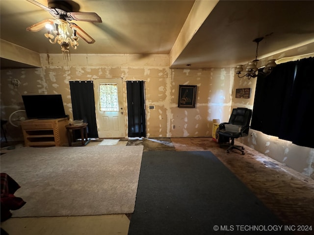 living room with ceiling fan with notable chandelier