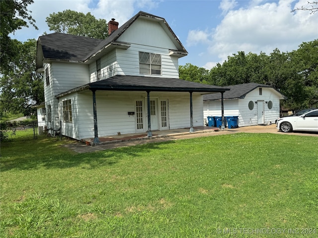 view of front of home with covered porch and a front yard