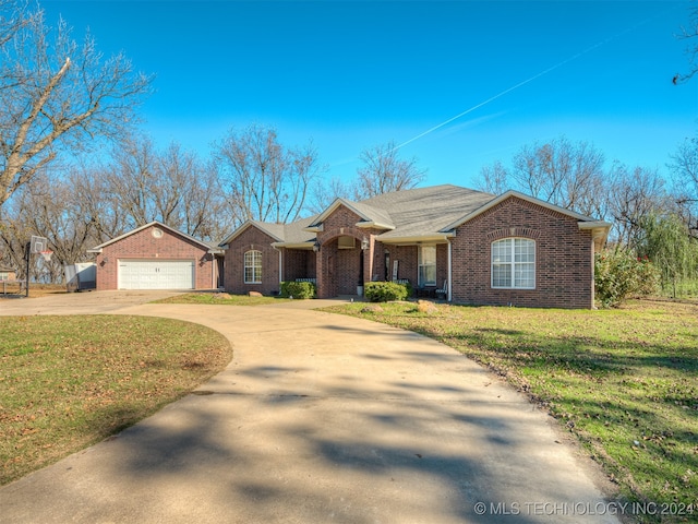 single story home featuring a front yard and a garage