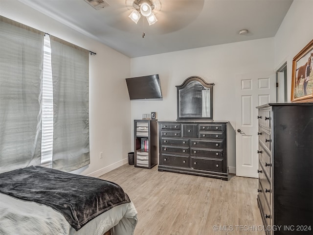 bedroom featuring multiple windows, light wood-type flooring, and ceiling fan