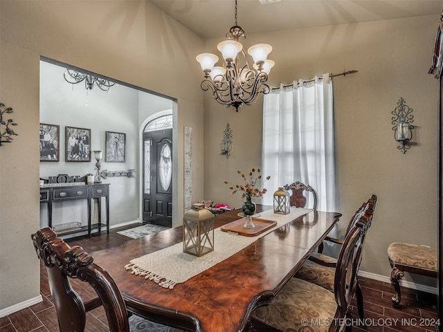 dining space with a chandelier and dark hardwood / wood-style floors