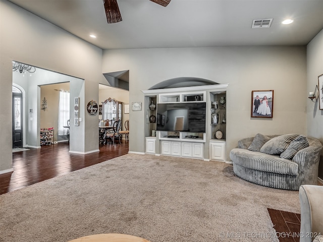 living room with ceiling fan, dark hardwood / wood-style flooring, and high vaulted ceiling