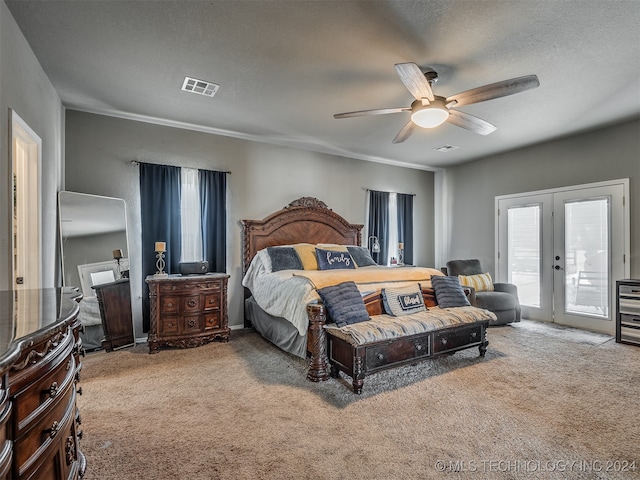 carpeted bedroom with access to outside, ceiling fan, french doors, and a textured ceiling