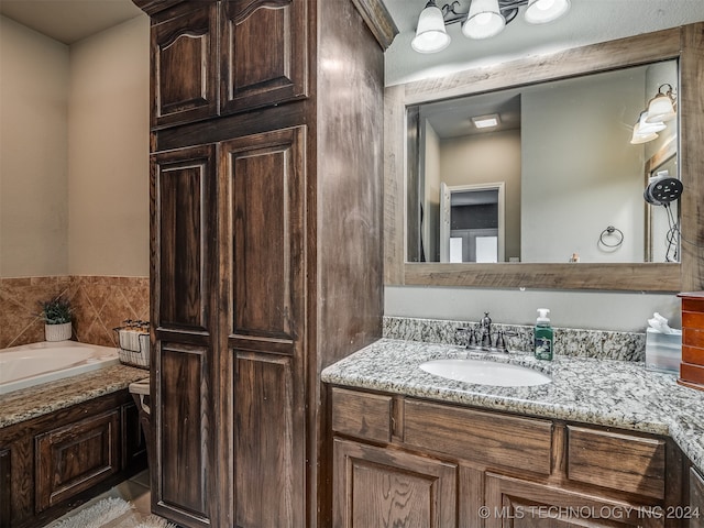 bathroom featuring vanity and a bath