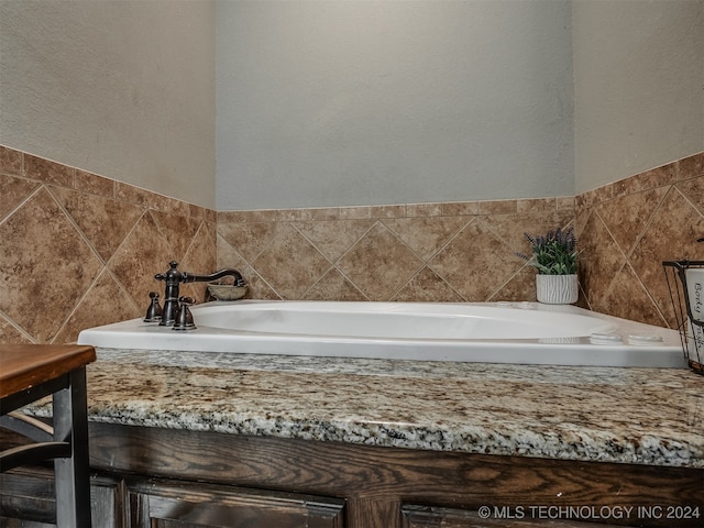 bathroom featuring tile walls and a bathing tub