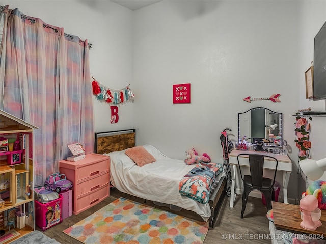 bedroom with dark wood-type flooring