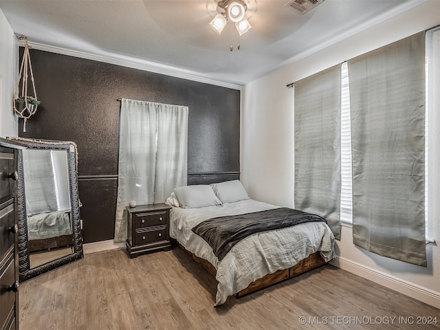 bedroom featuring light hardwood / wood-style flooring and ceiling fan