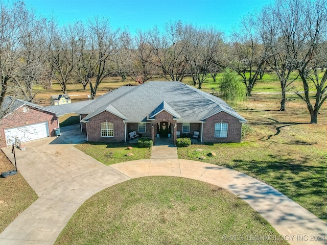 single story home featuring a garage and a front lawn