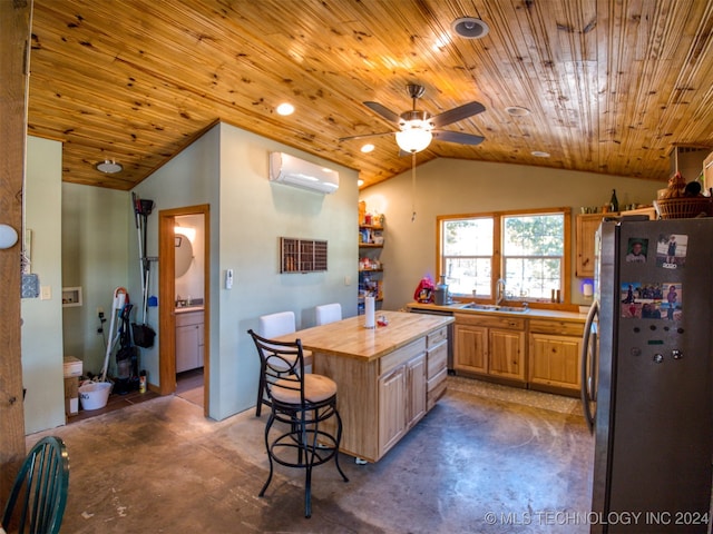 kitchen featuring sink, wooden ceiling, a wall unit AC, stainless steel fridge, and vaulted ceiling