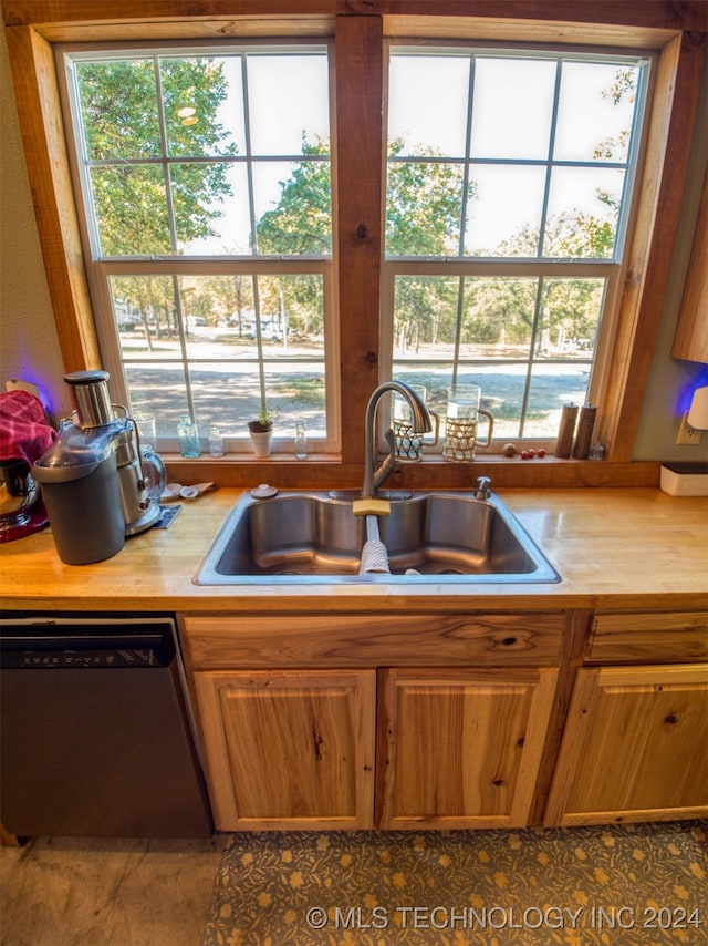 kitchen with dishwasher, tile patterned flooring, and sink