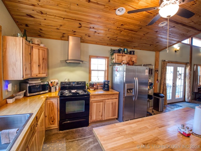 kitchen with wooden ceiling, french doors, stainless steel appliances, and wall chimney exhaust hood