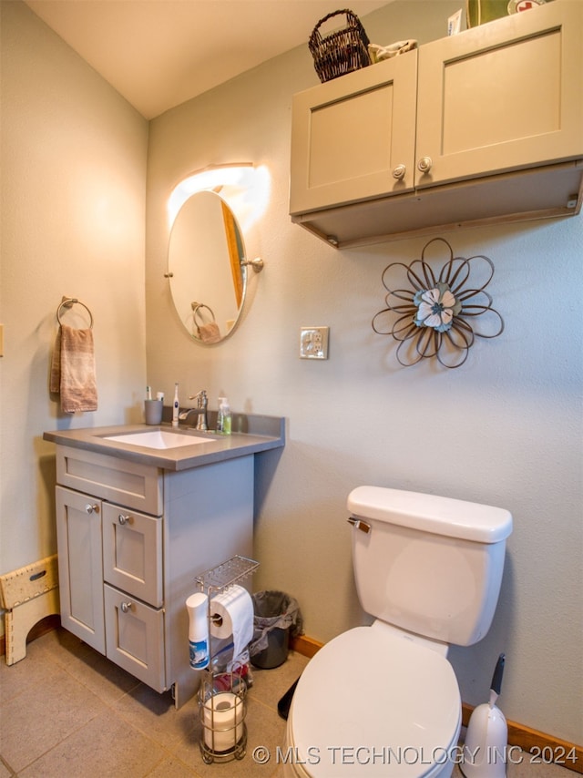 bathroom with tile patterned floors, vanity, and toilet