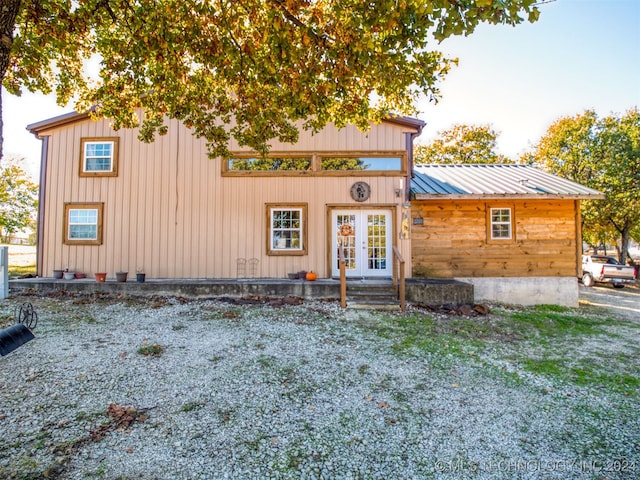 view of front of house featuring a front lawn and french doors