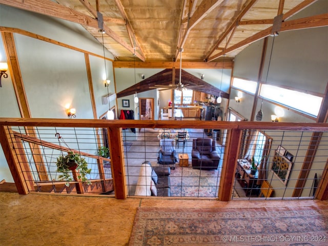 interior space featuring vaulted ceiling with beams, carpet floors, and wooden ceiling