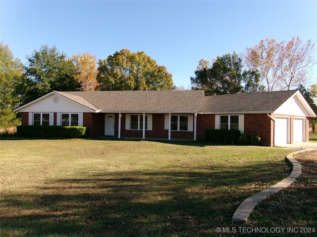 ranch-style house with a garage and a front lawn