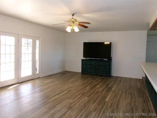 unfurnished living room with ceiling fan and dark hardwood / wood-style flooring