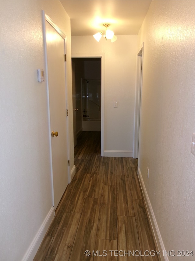 corridor featuring dark hardwood / wood-style floors