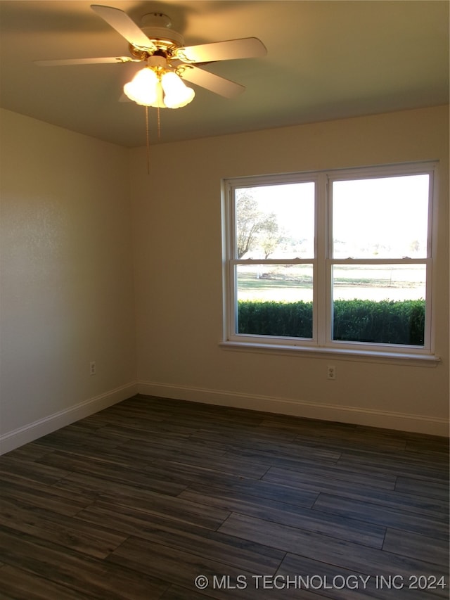 empty room with ceiling fan and dark wood-type flooring